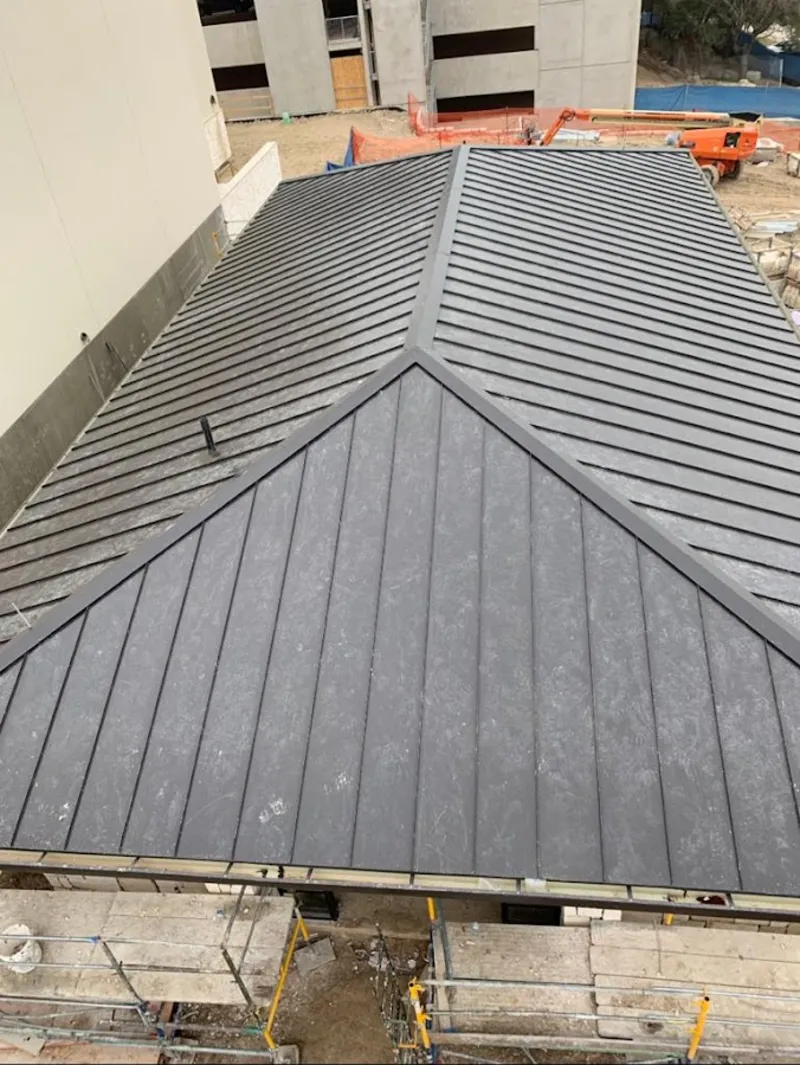 Commercial metal roof construction with crane equipment in East Vincent