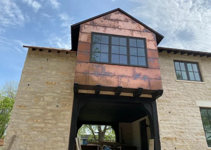 Copper metal panel facade on a stone building for Skylight Installation in East Vincent